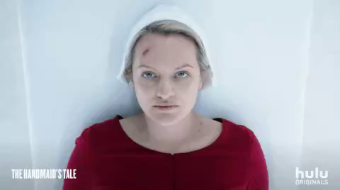 A Handmaid's Tale gif:

Close-up of OfFred, with dead eyes, saying: 
"Blessed Day"

She wears her red and white uniform and has a red wound on her forehead.