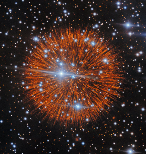 A spherical structure made up of long, narrow, radial spikes emanating from its centre. This is the supernova ejecta. Many stars of the Galaxy surround it.