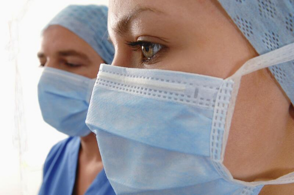 Nurses wearing baggy blue masks