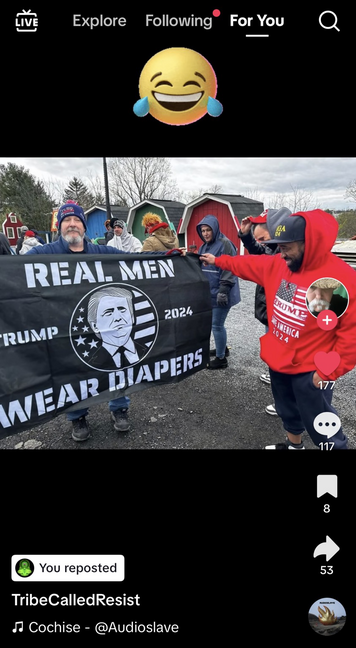 Screenshot of a TikTok video showing actual MAGA cult members outside a Trump rally proudly displaying their large Trump 2024 flag with slogan “REAL MEN WEAR DIAPERS.”