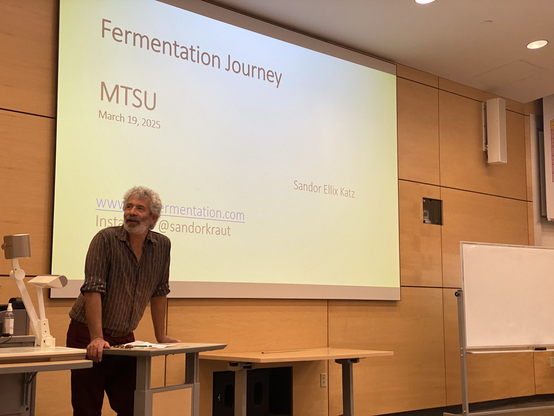 Sandor Katz at the podium telling how he became interested in fermented foods.