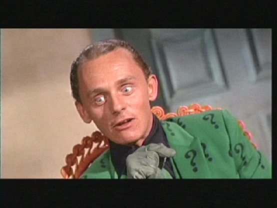 Photo of Frank Gorshin as The Riddler on the Batman TV show asking a riddle.